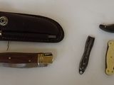a knife, knife sharper, and other items that are on a table