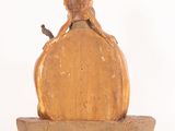 a statue of a woman sitting on top of a block