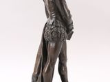 an image of a statue of a man standing on a wooden base