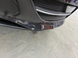 a close up of a black car with a license plate on it