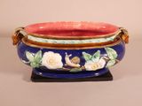 a blue bowl with white flowers and a snail on it