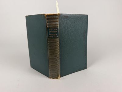 an old book with a gold binding and a green cover