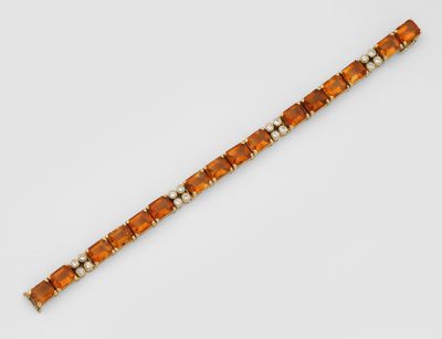 an orange glass beaded bracelet on a white background