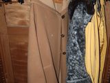 a coat rack with coats hanging on it in a closet
