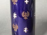 a blue cup with gold crosses and crosses on it