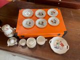 a table with a tea set on it and a box on the table