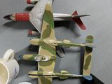 a model of a plane on a table next to a coffee cup