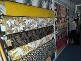 many different types of fabrics on display in a store