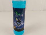 a bottle of blue liquid sitting on top of a white table