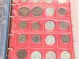 a red binder with a bunch of coins inside of it