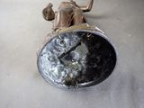 a silver clock sitting on top of a table