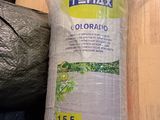 a roll of plastic on the floor next to a plastic bag