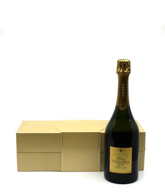bottle of champagne next to a box of chocolates on a white surface