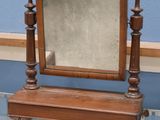 a small mirror on a glass table in a room