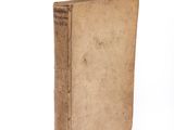 an old book sitting on top of a table next to a white background