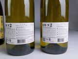 three bottles of wine sitting next to each other on a table