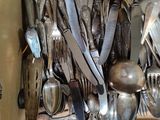 many spoons and spoon knives in a box
