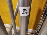 a metal pole with a sticker on it in front of a yellow wall