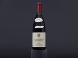a bottle of wine sitting on top of a black table