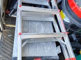 a ladder that is sitting in the back of a truck