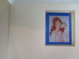 a picture of a little girl that is hanging on the wall