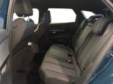 the back seats of a blue car are empty and the passenger seat is empty