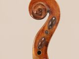 an old violin with a wooden bow on a white background