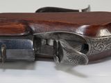 a close up of a gun on a table with a white background