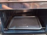 a person taking a picture of the inside of an oven