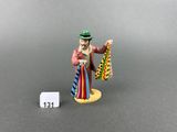 a small figurine of a man with a tie and hat