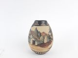 a small vase with a painting on it on a white surface