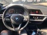 someone is sitting in the driver ' s seat of a bmw car