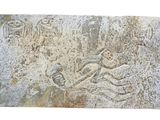 a stone carving of a man and a woman on a horse