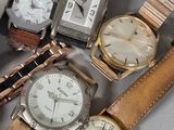 a lot of watches that are sitting together on a table