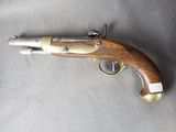 an old gun with a wooden handle on a gray surface