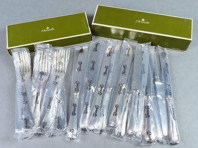 six fourchettes d'argenterie dans une boîte verte, avec une autre boîte verte à côté