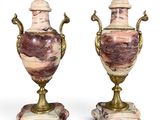 pair of pink and gold vases on marble bases on a white background