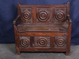 an old wooden bench with carvings on the back of it