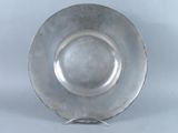 an antique silver plate on a stand on a white background