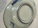 a white plate with a blue design on it