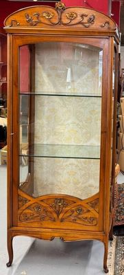 a display case with a glass door in a room