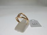 an image of a gold ring on a white surface with a price tag