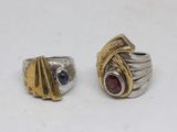 two silver and gold rings with garnets and garnets on them