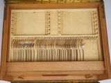 a wooden box with silverware in it on a table