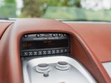 a car dashboard with a digital clock in the center
