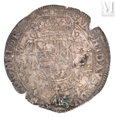 a close up of an old silver coin on a white surface