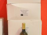 boxes of wine and a bottle of wine sit on a table