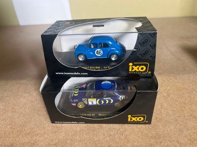 two toy cars are in a box on a table