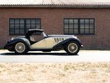 a black and white car parked in front of a brick building