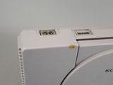 a close up of a white washing machine on a table